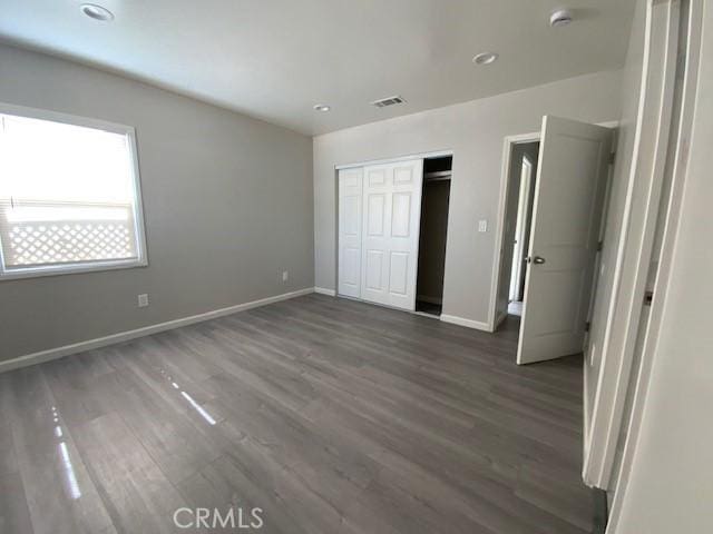 840 W 27th St, San Bernardino, CA 92405 - unfurnished bedroom with wood finished floors, a closet, and recessed lighting