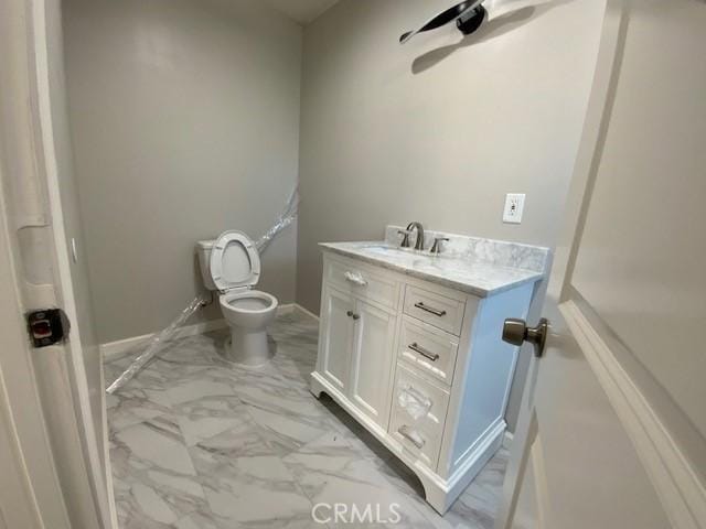 840 W 27th St, San Bernardino, CA 92405 - bathroom with marble look tile flooring, vanity, and a ceiling fan