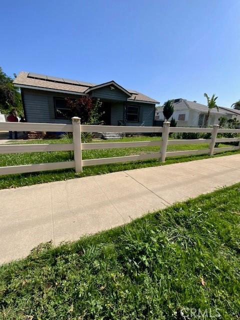 840 W 27th St, San Bernardino, CA 92405 - single story home with solar panels and a fenced front yard