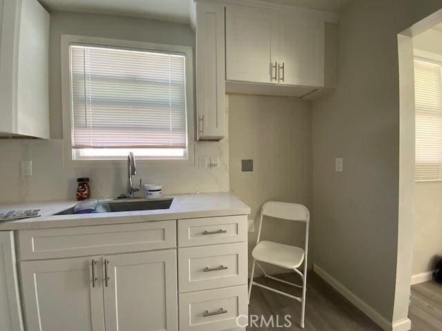 840 W 27th St, San Bernardino, CA 92405 - kitchen featuring wood finished floors, light countertops, and white cabinetry