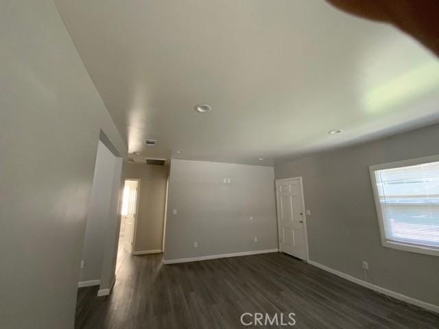 840 W 27th St, San Bernardino, CA 92405 - unfurnished living room with dark wood-style flooring and recessed lighting