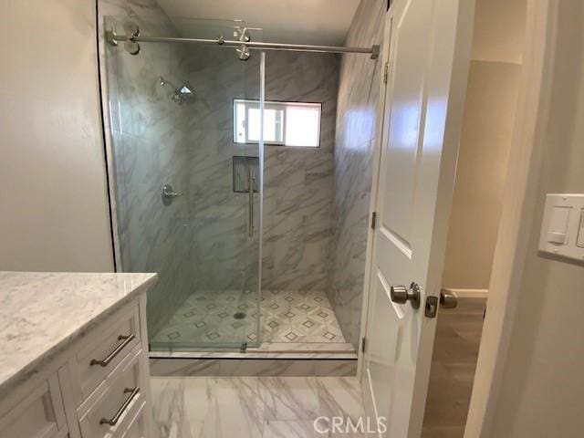 840 W 27th St, San Bernardino, CA 92405 - bathroom with a shower stall, vanity, and marble look tiles