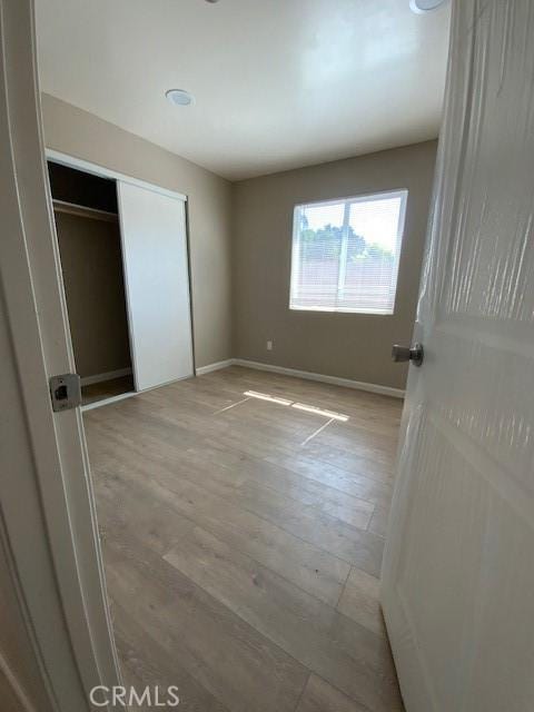 840 W 27th St, San Bernardino, CA 92405 - unfurnished bedroom featuring light wood-type flooring and a closet