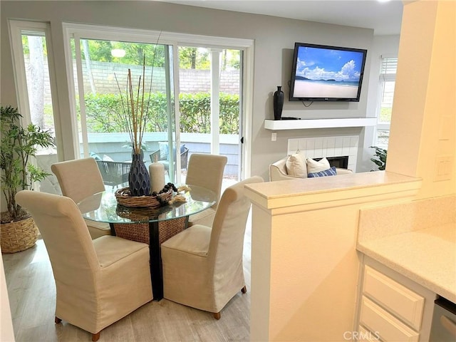 19311 Sunray Ln Unit 104, Huntington Beach, CA 92648 - dining space featuring light wood-style flooring and a tile fireplace