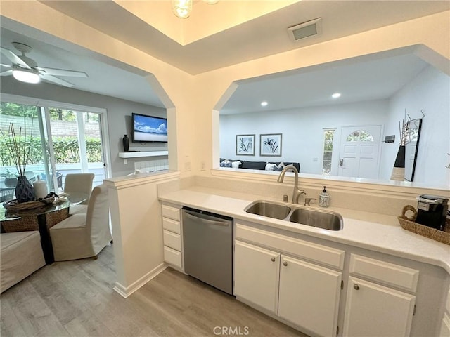 19311 Sunray Ln Unit 104, Huntington Beach, CA 92648 - kitchen with stainless steel dishwasher, light wood-style floors, light countertops, white cabinetry, and ceiling fan