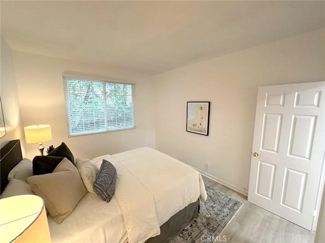 19311 Sunray Ln Unit 104, Huntington Beach, CA 92648 - bedroom with light wood-style flooring and baseboards