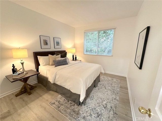 19311 Sunray Ln Unit 104, Huntington Beach, CA 92648 - bedroom featuring baseboards and wood finished floors