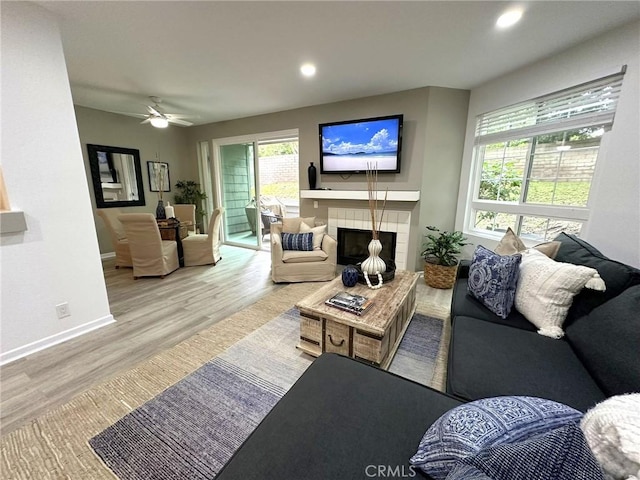 19311 Sunray Ln Unit 104, Huntington Beach, CA 92648 - living area with wood finished floors, a ceiling fan, recessed lighting, and a tile fireplace