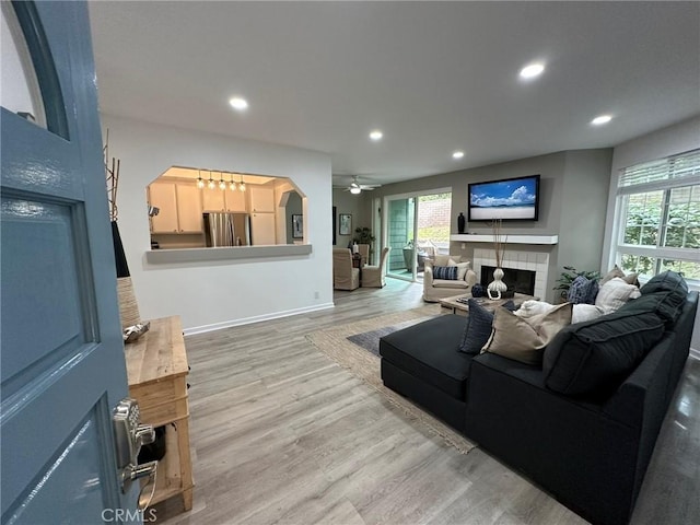 19311 Sunray Ln Unit 104, Huntington Beach, CA 92648 - living room with a tiled fireplace, wood finished floors, healthy amount of natural light, a ceiling fan, and recessed lighting