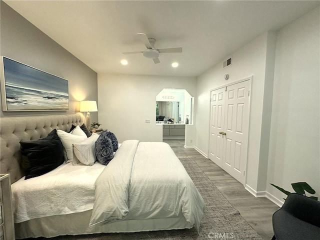 19311 Sunray Ln Unit 104, Huntington Beach, CA 92648 - bedroom featuring wood finished floors, recessed lighting, a closet, ceiling fan, and arched walkways