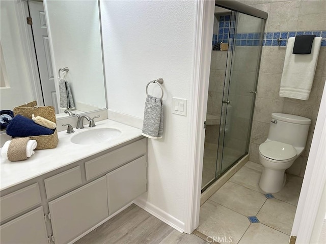 19311 Sunray Ln Unit 104, Huntington Beach, CA 92648 - bathroom featuring vanity, a shower stall, and wood finished floors