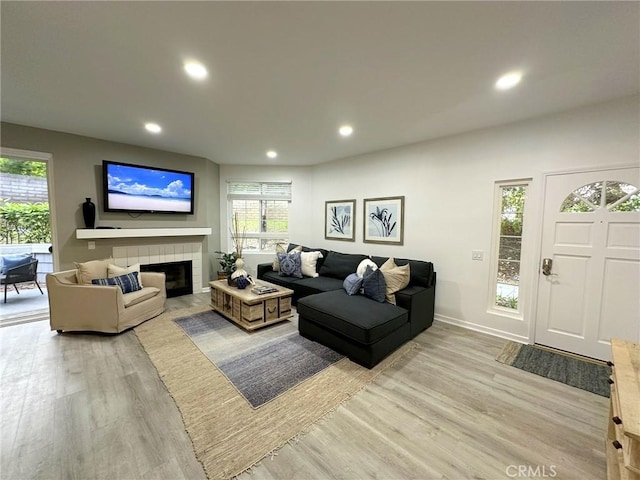 19311 Sunray Ln Unit 104, Huntington Beach, CA 92648 - living room featuring light wood-type flooring, recessed lighting, and a tile fireplace