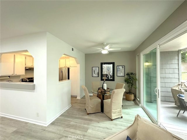 19311 Sunray Ln Unit 104, Huntington Beach, CA 92648 - dining area with light wood-style flooring, a ceiling fan, and arched walkways