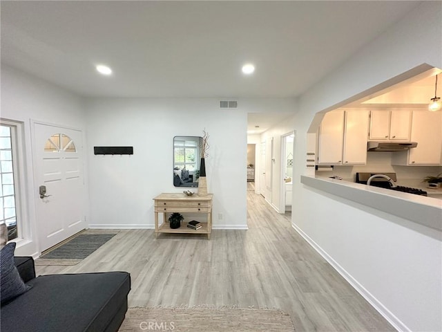 19311 Sunray Ln Unit 104, Huntington Beach, CA 92648 - living room featuring light wood-style floors and recessed lighting