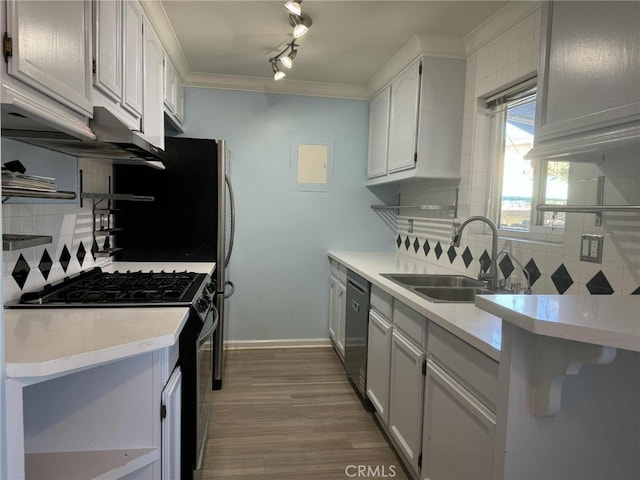 11138 Aqua Vista St Unit 3, Studio City, CA 91602 - kitchen featuring gas range, stainless steel dishwasher, decorative backsplash, light countertops, and crown molding