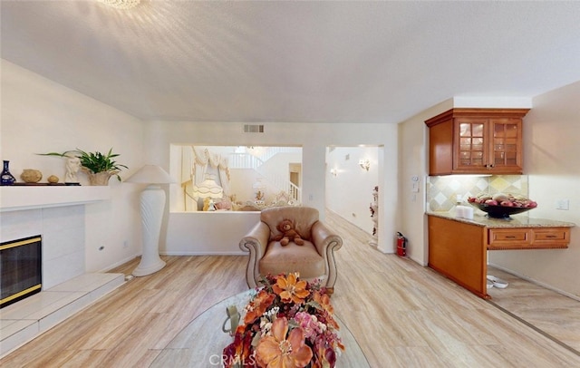 220 S Linhaven Cir, Anaheim, CA 92804 - living area with light wood-style floors and a tile fireplace