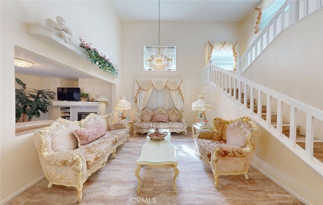 220 S Linhaven Cir, Anaheim, CA 92804 - living area with stairway, a towering ceiling, wood finished floors, and a chandelier
