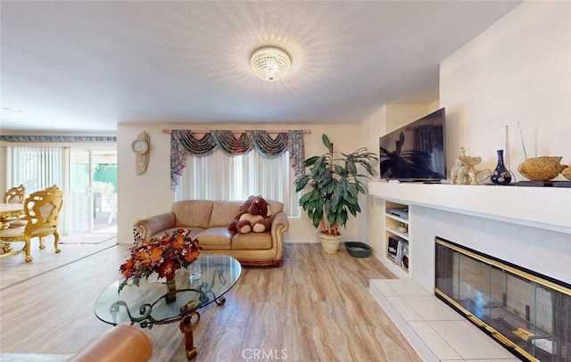 220 S Linhaven Cir, Anaheim, CA 92804 - living room with light wood-style floors and a fireplace