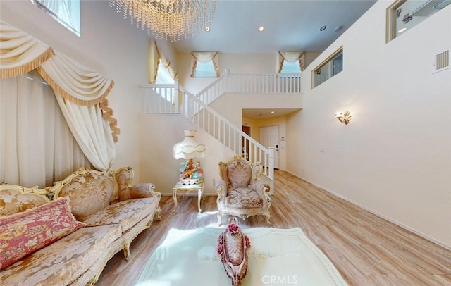 220 S Linhaven Cir, Anaheim, CA 92804 - living area with a chandelier, wood finished floors, stairway, and a high ceiling