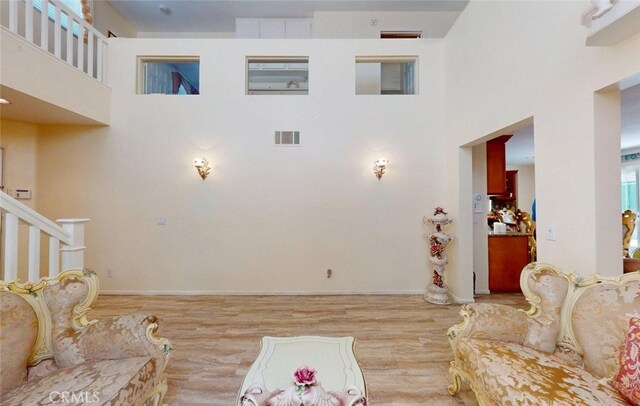 220 S Linhaven Cir, Anaheim, CA 92804 - living area featuring a towering ceiling, wood finished floors, and stairway