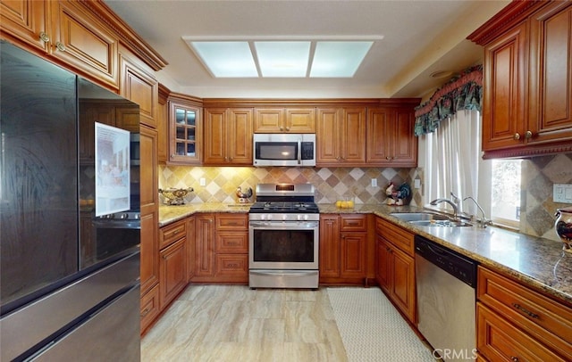 220 S Linhaven Cir, Anaheim, CA 92804 - kitchen with appliances with stainless steel finishes, brown cabinets, and decorative backsplash