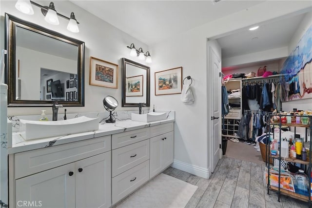1909 Arroyo Ave, Oceanside, CA 92056 - bathroom with double vanity, wood finished floors, and a walk in closet