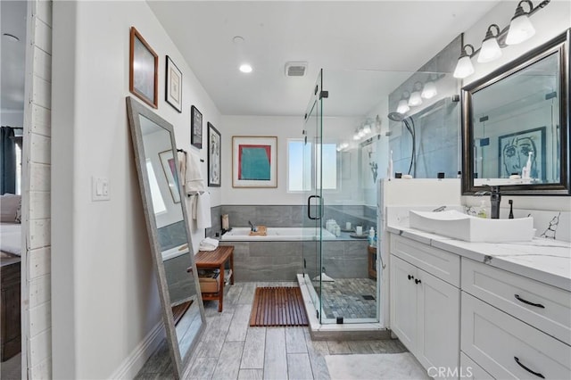 1909 Arroyo Ave, Oceanside, CA 92056 - full bathroom with vanity, a bath, a shower stall, and wood finished floors