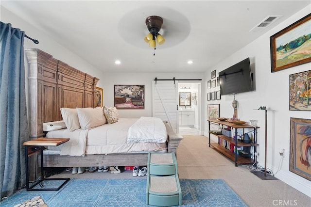 1909 Arroyo Ave, Oceanside, CA 92056 - bedroom with a barn door, light colored carpet, recessed lighting, connected bathroom, and a ceiling fan