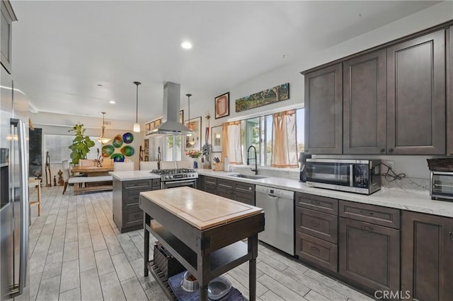 1909 Arroyo Ave, Oceanside, CA 92056 - kitchen featuring island range hood, appliances with stainless steel finishes, dark brown cabinets, a peninsula, and recessed lighting