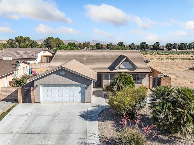 27239 Peach Tree Ln, Helendale, CA 92342 - ranch-style house with a garage, driveway, a gate, and a tiled roof