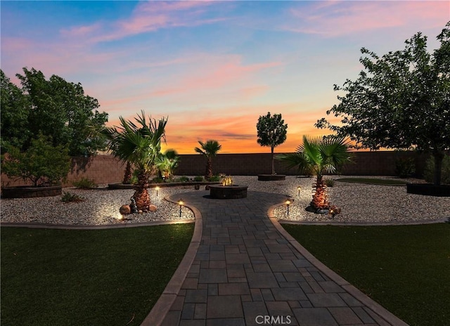 27239 Peach Tree Ln, Helendale, CA 92342 - yard at dusk featuring a fire pit, a patio, and a fenced backyard