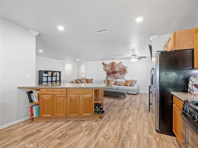 27239 Peach Tree Ln, Helendale, CA 92342 - kitchen with black range with gas stovetop, ceiling fan, light wood-style flooring, open floor plan, and recessed lighting