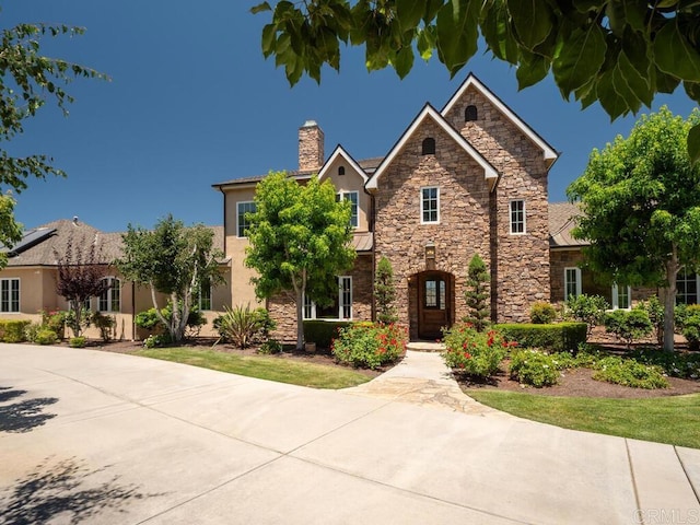 32110 Dos Ninas, Bonsall, CA 92003 - view of front facade with stone siding, stucco siding, and a chimney
