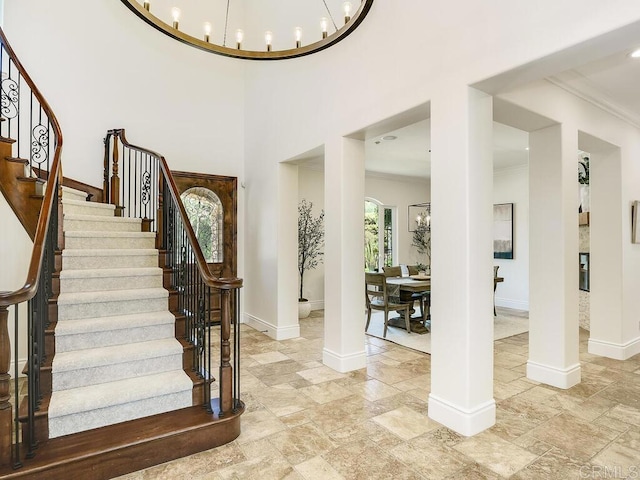 32110 Dos Ninas, Bonsall, CA 92003 - foyer entrance with crown molding, stone tile flooring, stairs, and a chandelier