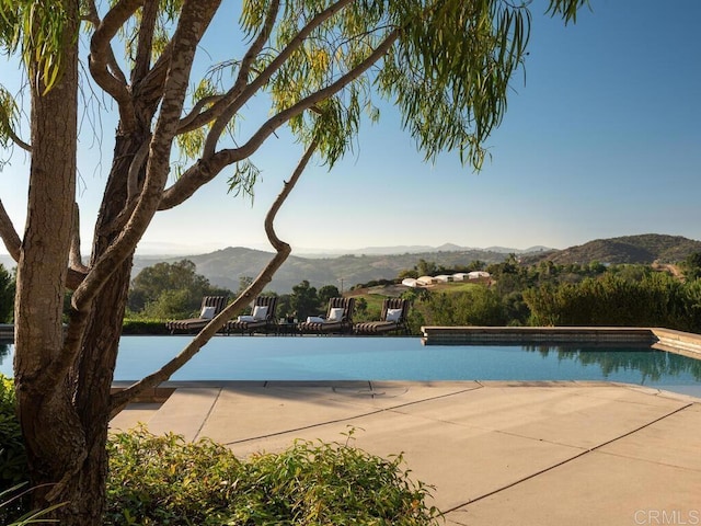 32110 Dos Ninas, Bonsall, CA 92003 - view of pool with a mountain view, an infinity pool, and a patio area