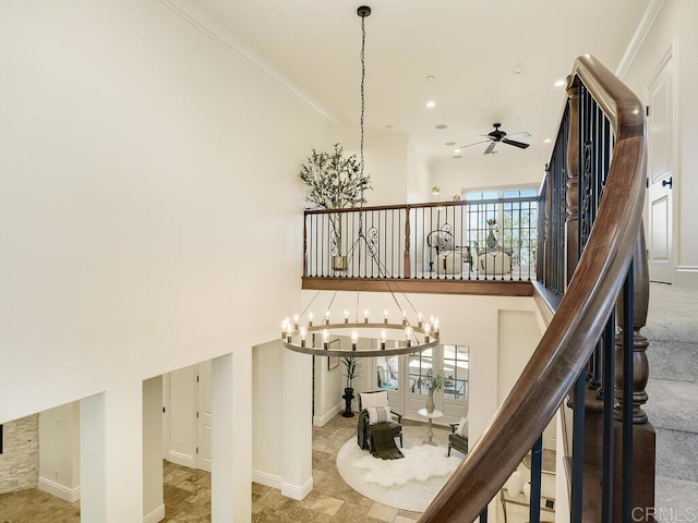 32110 Dos Ninas, Bonsall, CA 92003 - stairway featuring a chandelier, ceiling fan, ornamental molding, and a high ceiling