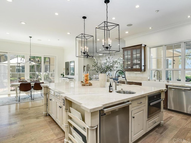 32110 Dos Ninas, Bonsall, CA 92003 - kitchen with dishwasher, a chandelier, a kitchen island with sink, ornamental molding, and glass insert cabinets