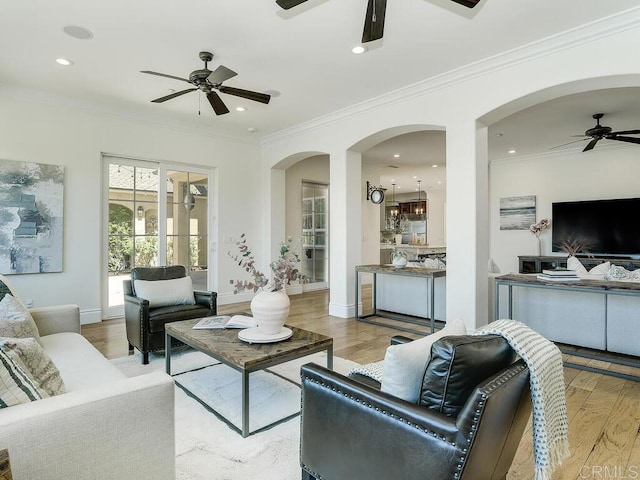 32110 Dos Ninas, Bonsall, CA 92003 - living room featuring a ceiling fan, wood finished floors, arched walkways, ornamental molding, and recessed lighting