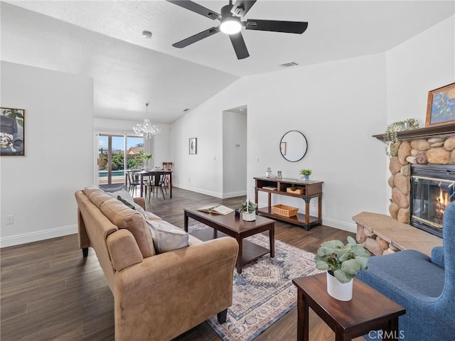 22163 Broken Lance Rd, Apple Valley, CA 92307 - living area featuring a chandelier, vaulted ceiling, dark wood-style flooring, ceiling fan, and a fireplace