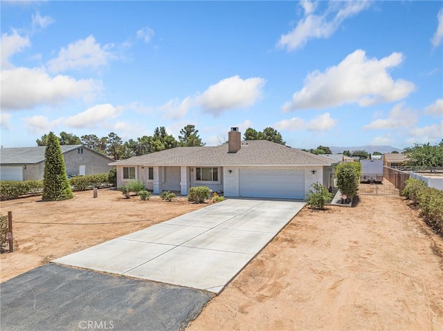 22163 Broken Lance Rd, Apple Valley, CA 92307 - ranch-style house with concrete driveway, a garage, and a chimney