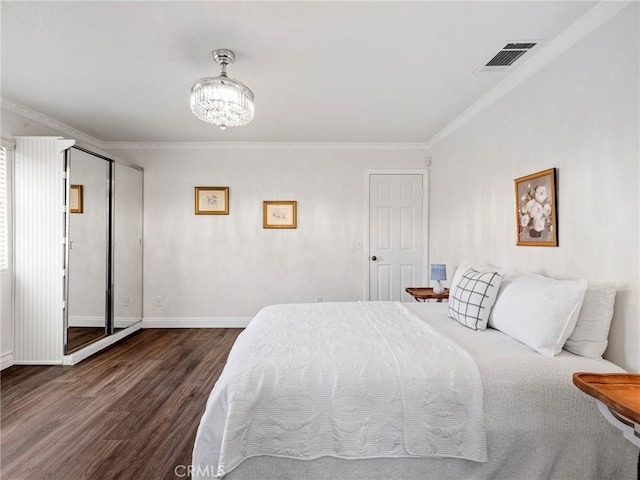 22163 Broken Lance Rd, Apple Valley, CA 92307 - bedroom with dark wood-style flooring, ornamental molding, and a chandelier