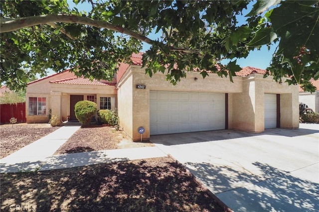 4242 Trenton Ave, Palmdale, CA 93552 - mediterranean / spanish home with stucco siding, a tiled roof, and concrete driveway