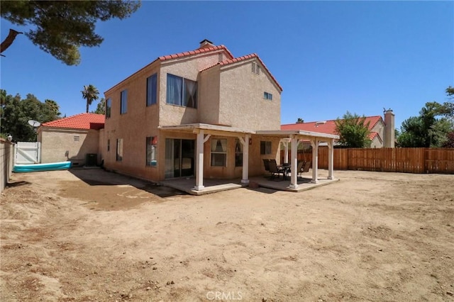 4242 Trenton Ave, Palmdale, CA 93552 - back of house with stucco siding, a tiled roof, a patio, and a fenced backyard