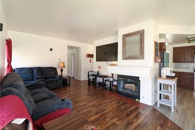 4242 Trenton Ave, Palmdale, CA 93552 - living area with dark wood-type flooring and a glass covered fireplace