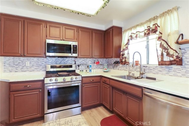 4242 Trenton Ave, Palmdale, CA 93552 - kitchen featuring appliances with stainless steel finishes, light countertops, and light wood-style floors