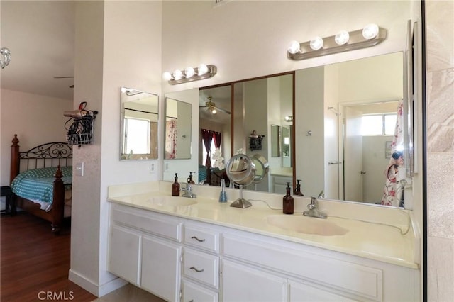 4242 Trenton Ave, Palmdale, CA 93552 - bathroom with double vanity, a ceiling fan, ensuite bath, and wood finished floors