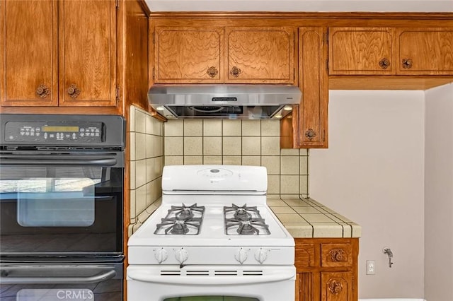 45660 Shain Ave, Dos Palos, CA 93620 - kitchen featuring gas range gas stove, range hood, oven, tile countertops, and decorative backsplash