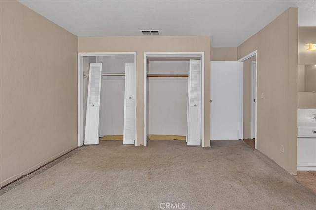 45660 Shain Ave, Dos Palos, CA 93620 - unfurnished bedroom featuring multiple closets and carpet floors