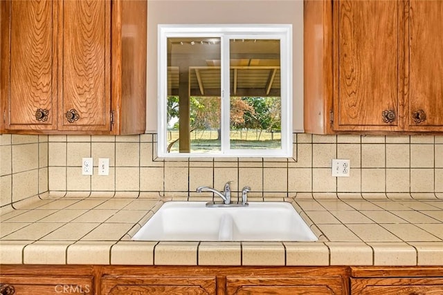 45660 Shain Ave, Dos Palos, CA 93620 - kitchen featuring brown cabinets, decorative backsplash, and tile counters