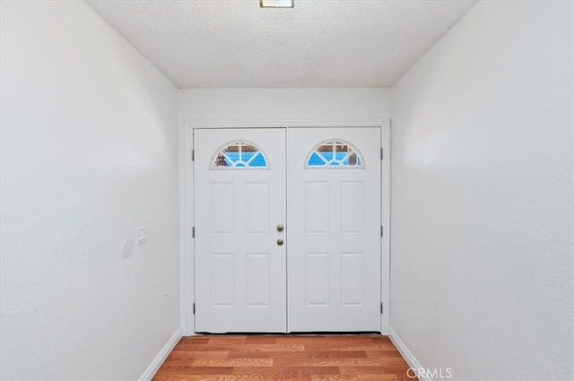 23405 Ramona Ave, Apple Valley, CA 92307 - foyer entrance with light wood-style floors and a textured ceiling